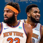 Mitchell Robinson in a New York Knicks uniform defending the rim during an NBA game