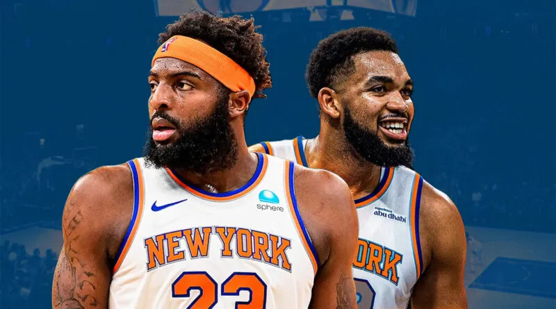 Mitchell Robinson in a New York Knicks uniform defending the rim during an NBA game