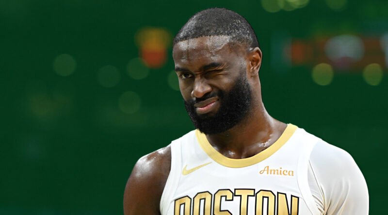 “Boston Celtics guard Jaylen Brown on the court as injury concerns arise before Raptors matchup.”